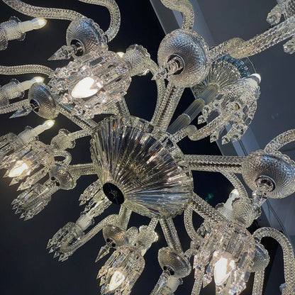 Close-up of a crystal chandelier with intricate design against a dark background